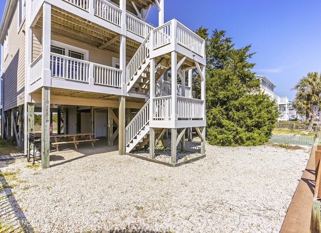 exterior space featuring a carport, stairway, a patio area, and fence