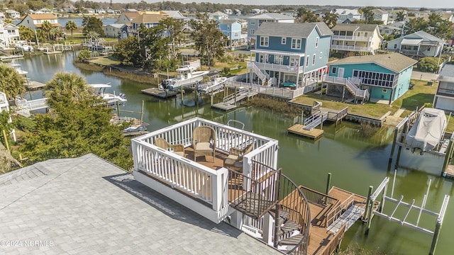 view of dock featuring stairs, a water view, boat lift, and a residential view