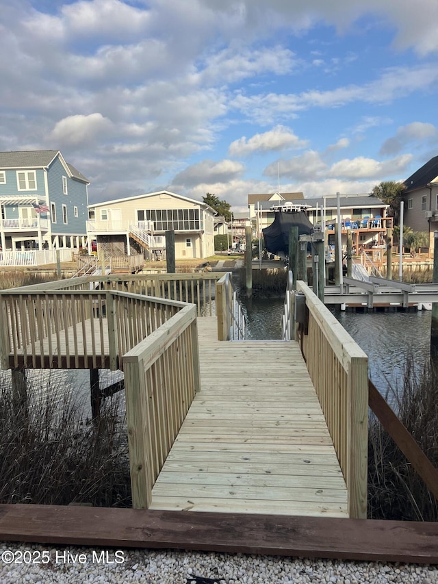 dock area featuring a residential view, a water view, and boat lift