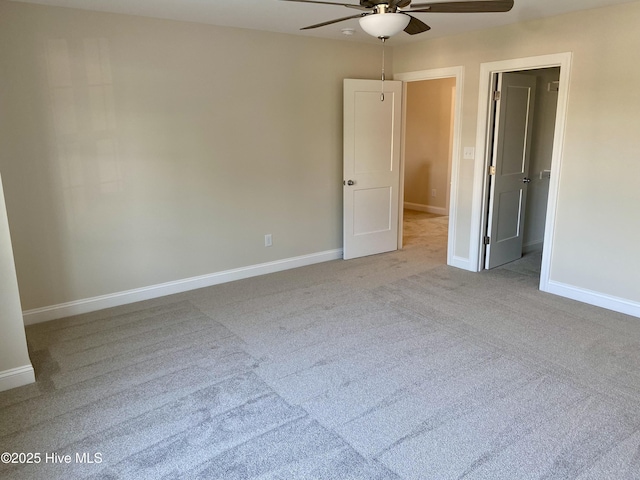 703 Henry Ln, Tarboro, NC 27886 - unfurnished bedroom featuring a spacious closet, carpet flooring, baseboards, and ceiling fan