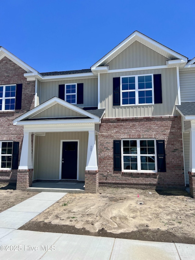 703 Henry Ln, Tarboro, NC 27886 - view of front of property with board and batten siding, a porch, and brick siding