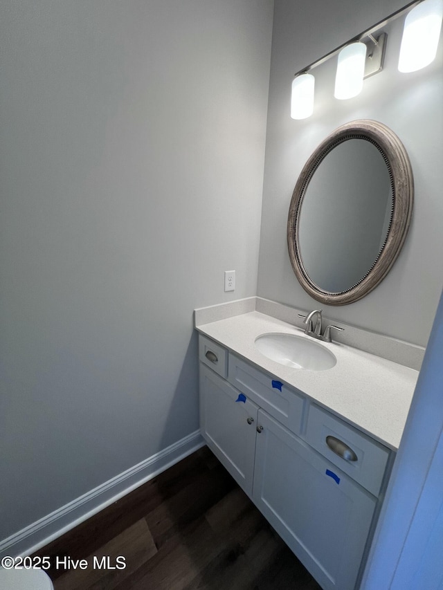 703 Henry Ln, Tarboro, NC 27886 - bathroom with vanity, baseboards, and wood finished floors