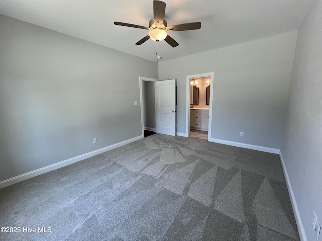 703 Henry Ln, Tarboro, NC 27886 - unfurnished bedroom with ensuite bath, baseboards, a ceiling fan, and carpet floors