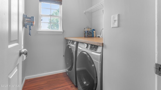 laundry room featuring separate washer and dryer and dark hardwood / wood-style floors