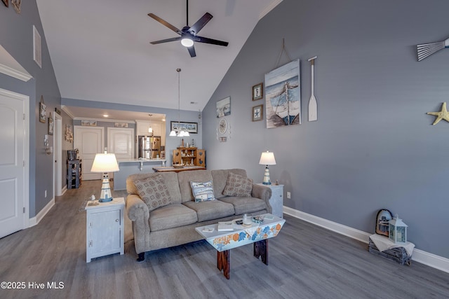 living room featuring ceiling fan, wood-type flooring, and high vaulted ceiling