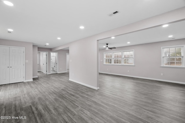 unfurnished living room featuring ceiling fan, dark hardwood / wood-style flooring, and a wealth of natural light