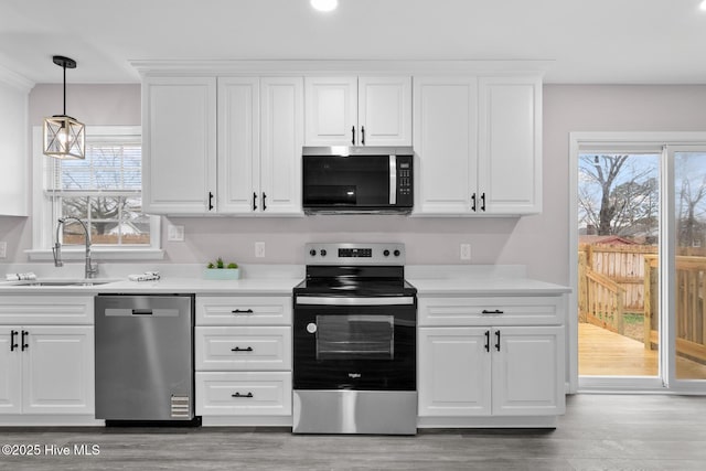 kitchen featuring sink, white cabinets, and appliances with stainless steel finishes