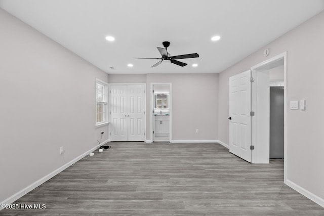 unfurnished room with ceiling fan and light wood-type flooring