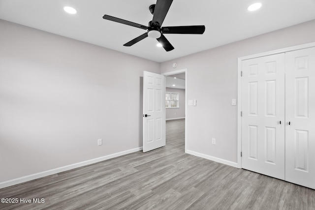 unfurnished bedroom with ceiling fan, light hardwood / wood-style floors, and a closet