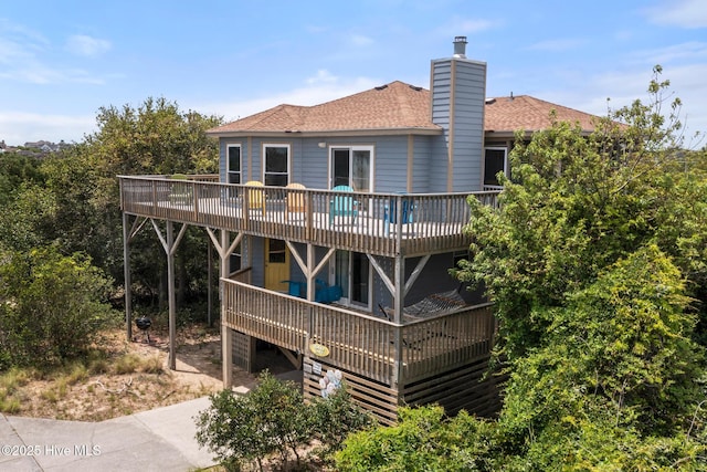 rear view of property featuring a deck