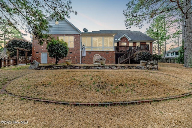 view of front facade featuring a front yard and a sunroom