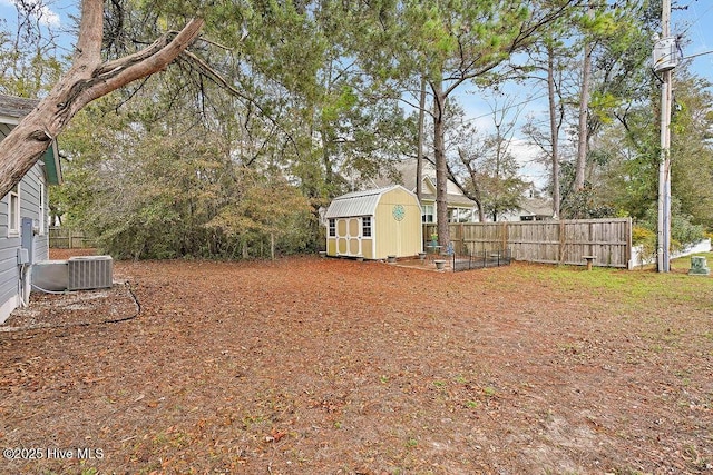 view of yard featuring central AC unit and a storage unit