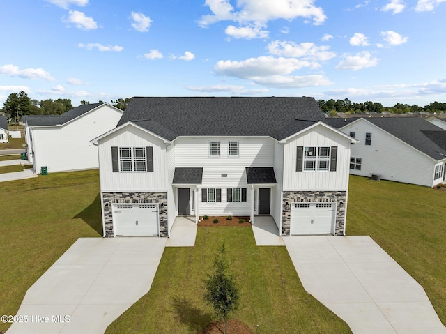 view of front of home with a garage, cooling unit, and a front lawn