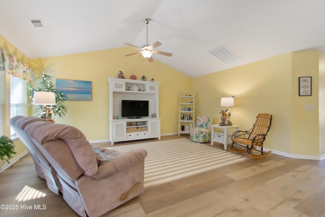 living room with hardwood / wood-style flooring, ceiling fan, and lofted ceiling