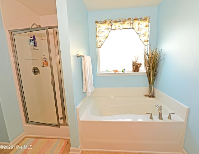 bathroom with shower with separate bathtub