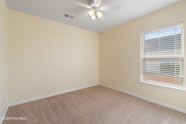 empty room with light colored carpet and ceiling fan