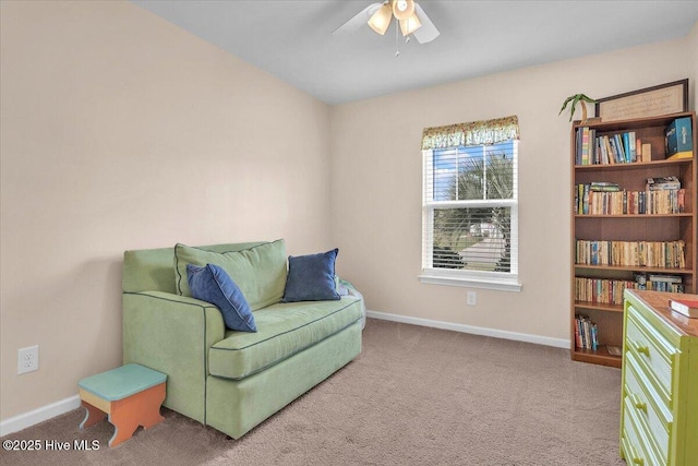 sitting room with ceiling fan and carpet flooring