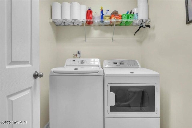 laundry area featuring washing machine and clothes dryer