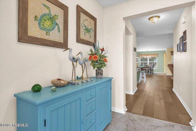 corridor with hardwood / wood-style floors