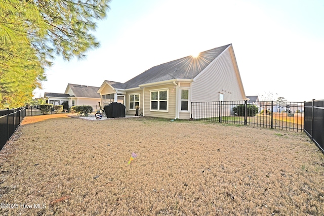 back of house with a lawn