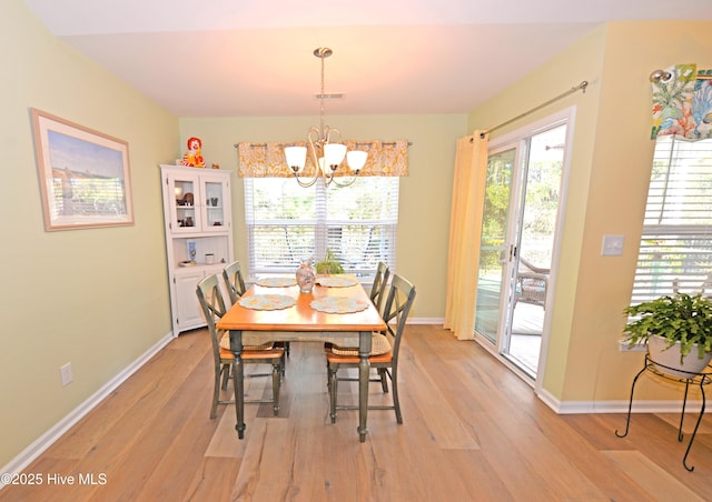 dining space featuring a chandelier and light hardwood / wood-style floors