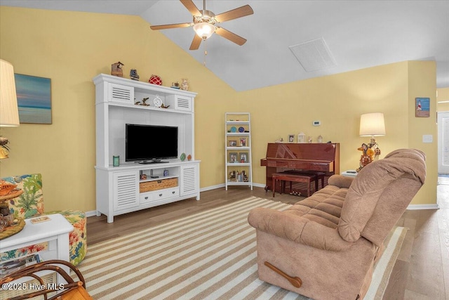 living room featuring lofted ceiling, hardwood / wood-style floors, and ceiling fan