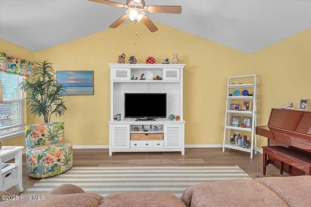 living room featuring vaulted ceiling, light hardwood / wood-style floors, and ceiling fan