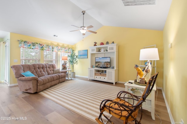 living room featuring lofted ceiling, ceiling fan, and light wood-type flooring