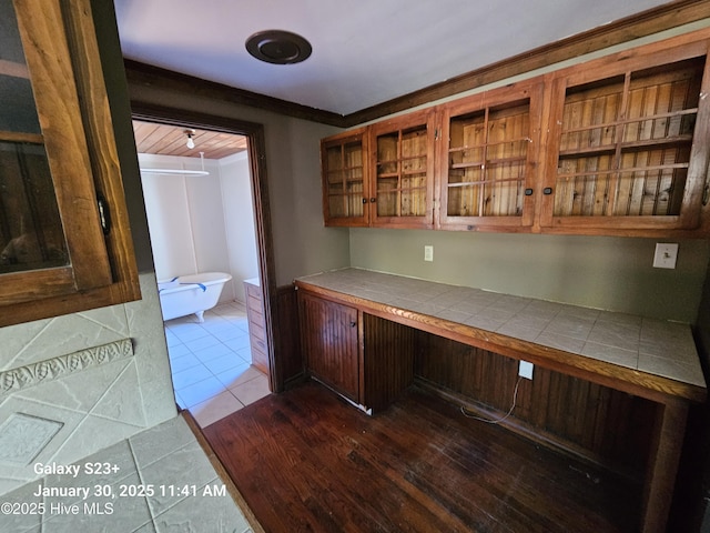 unfurnished office featuring built in desk and light tile patterned flooring