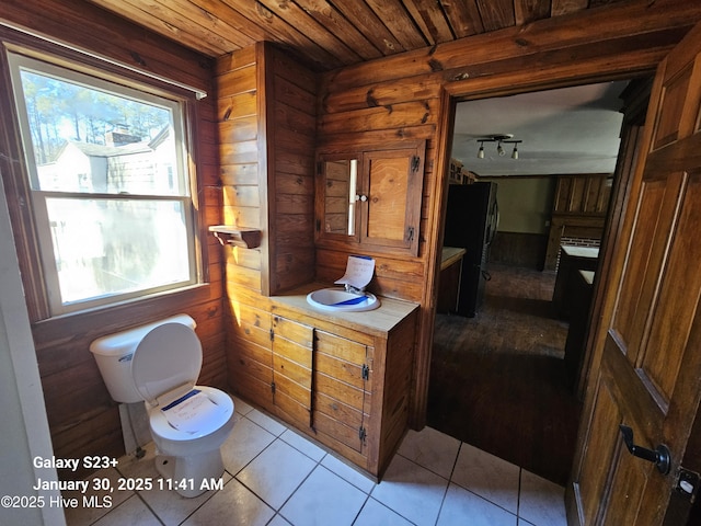 bathroom featuring rail lighting, vanity, wood ceiling, toilet, and tile patterned floors