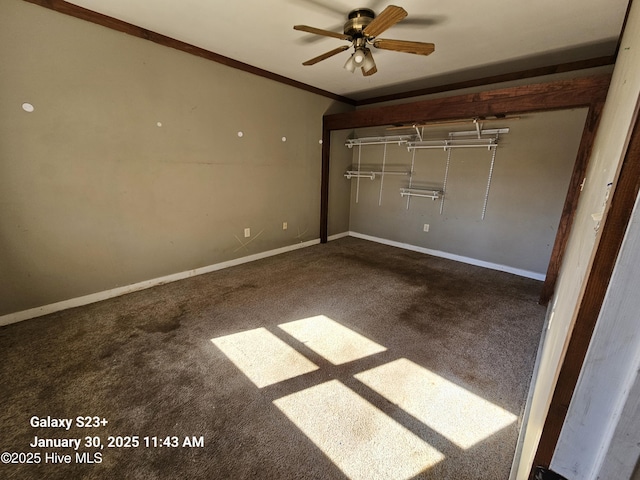 unfurnished bedroom featuring crown molding, carpet flooring, and a closet