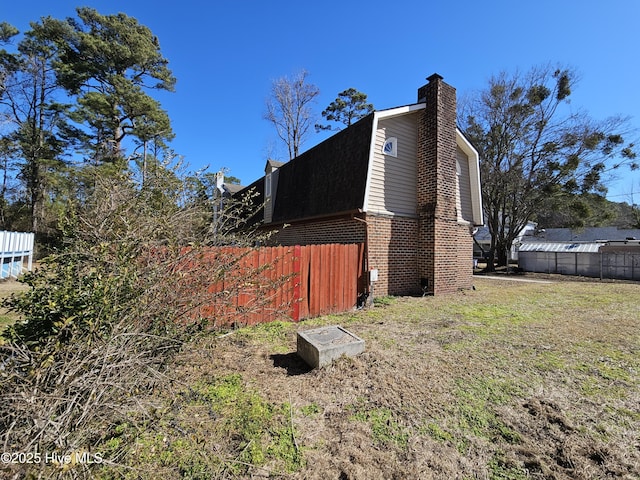 view of property exterior with a yard