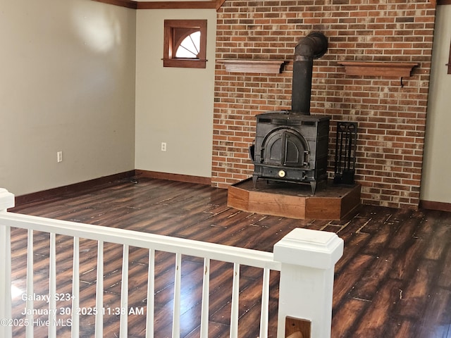 unfurnished living room featuring dark wood-type flooring and a wood stove