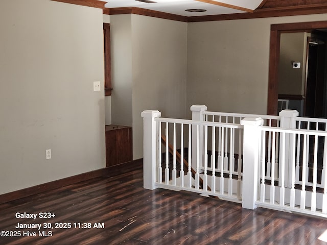 spare room with dark hardwood / wood-style flooring and ornamental molding