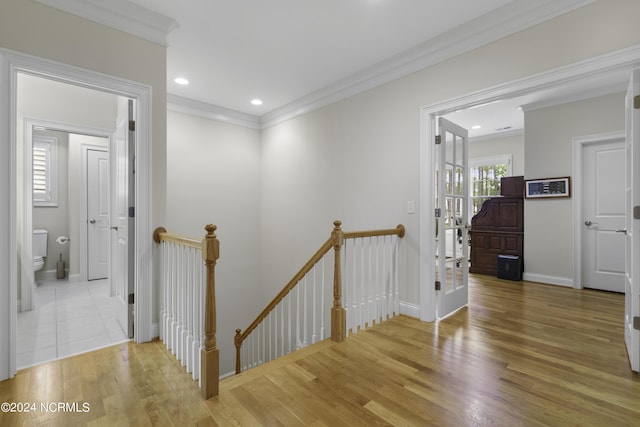 hall with crown molding and light wood-type flooring