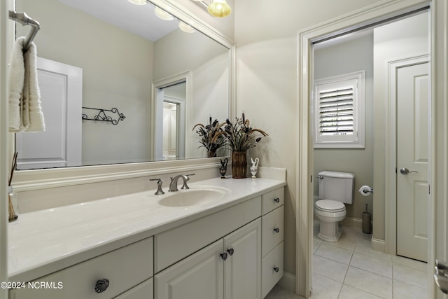 bathroom featuring tile patterned flooring, vanity, and toilet