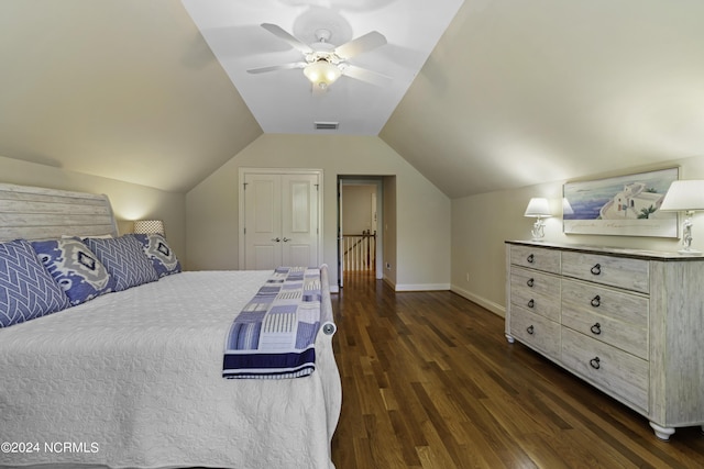 bedroom featuring dark wood-type flooring, ceiling fan, lofted ceiling, and a closet