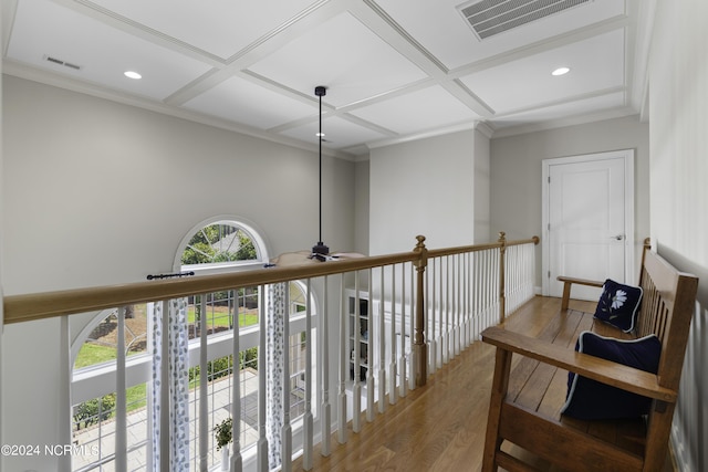 hall with coffered ceiling, wood-type flooring, and ornamental molding