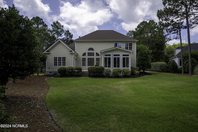 rear view of property with a lawn