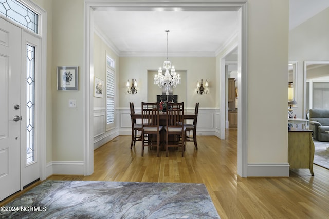 dining area featuring an inviting chandelier, plenty of natural light, and light wood-type flooring