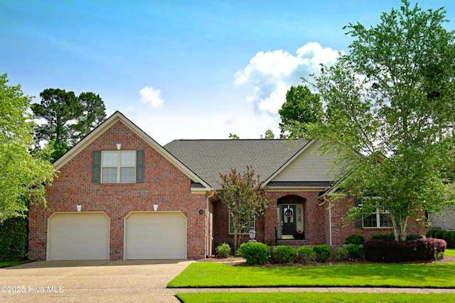 view of front of home with a front yard and a garage