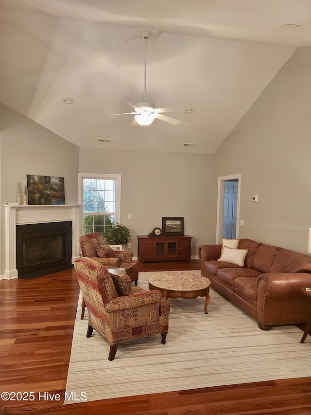 living room featuring hardwood / wood-style floors, vaulted ceiling, and ceiling fan