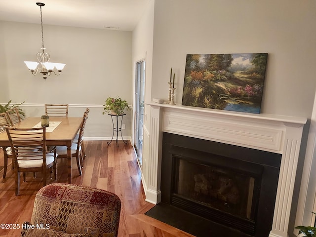 dining space featuring a notable chandelier and hardwood / wood-style flooring