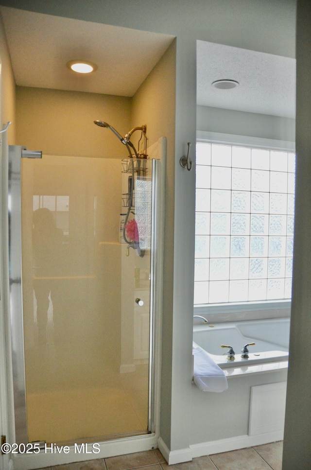 bathroom with plus walk in shower and tile patterned floors