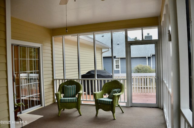 sunroom / solarium featuring ceiling fan