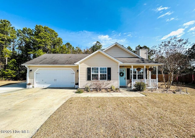 view of front of home featuring a garage, a front lawn, and a porch