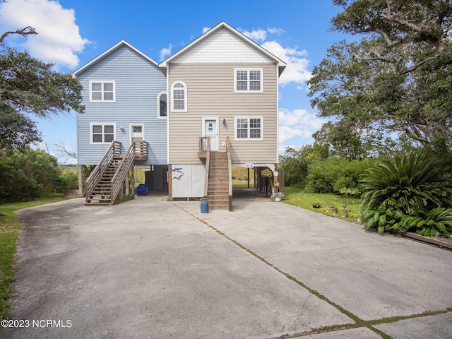 rear view of property with a carport