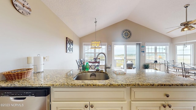 kitchen with sink, cream cabinets, stainless steel dishwasher, and light stone countertops