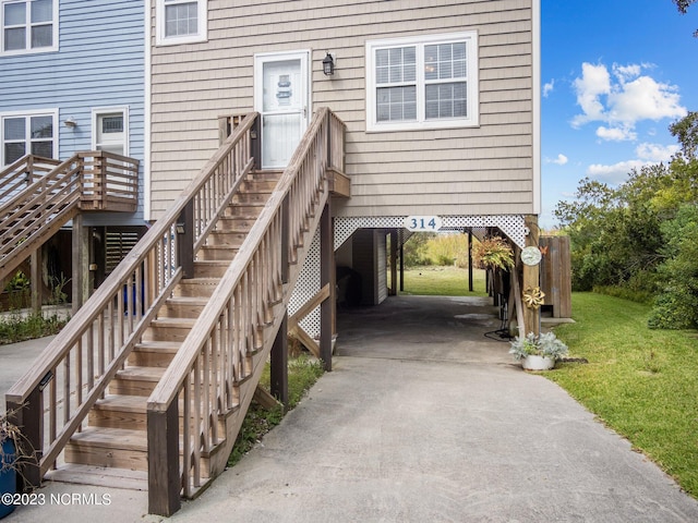 doorway to property featuring a lawn