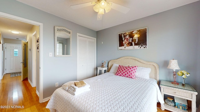 bedroom featuring light hardwood / wood-style floors, a closet, and ceiling fan